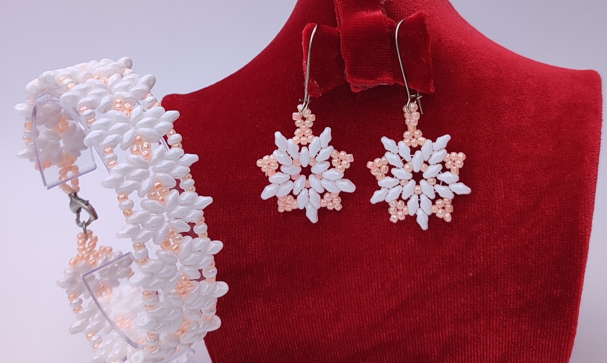 Handmade jewelry set from Arvimet with white and pink edges and a pink center, showcasing the exquisite Matubo Superduo Beads design—purchase today.